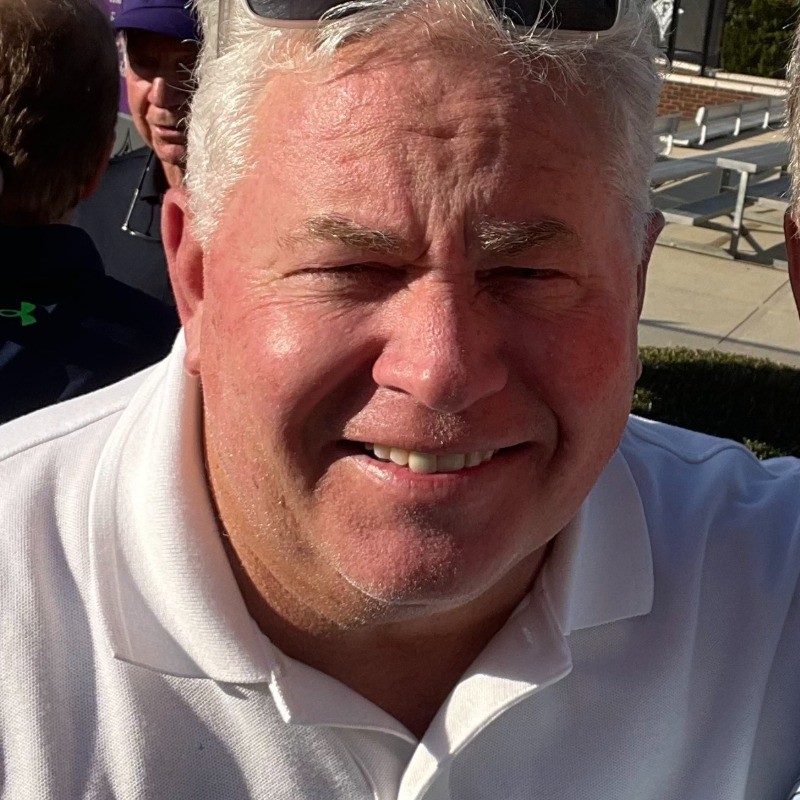 Sid Edmondson with blue paddle in pickleball yard