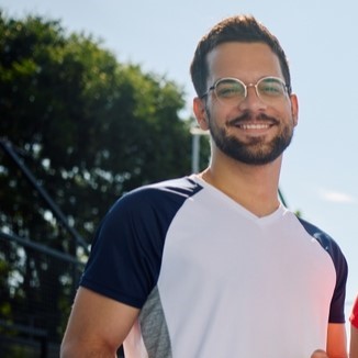 Sid sitting on pickleball court