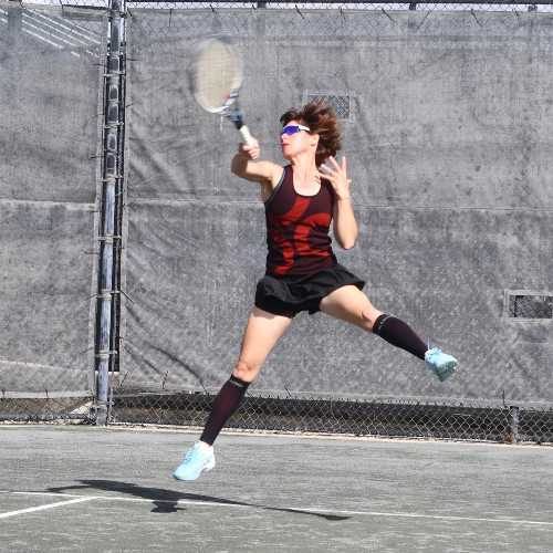 Sid Edmondson with blue paddle in pickleball yard