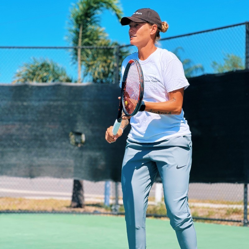 Sid Edmondson with blue paddle in pickleball yard