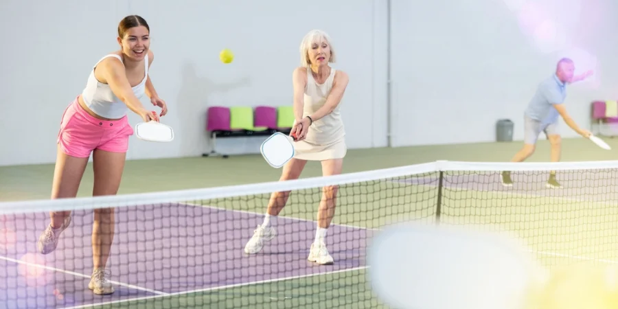 two ladies playing pickleball