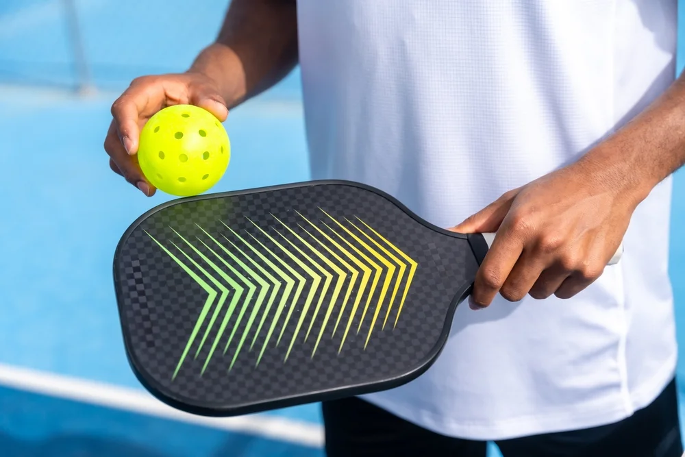 Fermin Mize holding pickleball paddle and ball