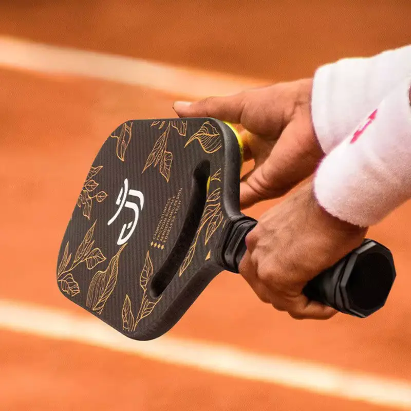 A player holding fiberglass pickleball paddle