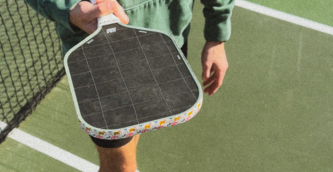 a player showing core thickness of pickleball paddle