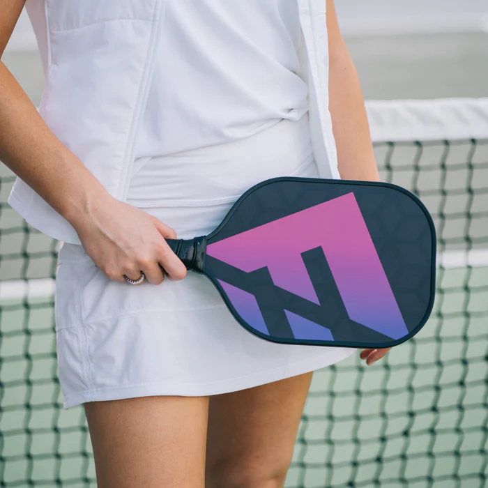 a woman player holding graphite pickleball paddle