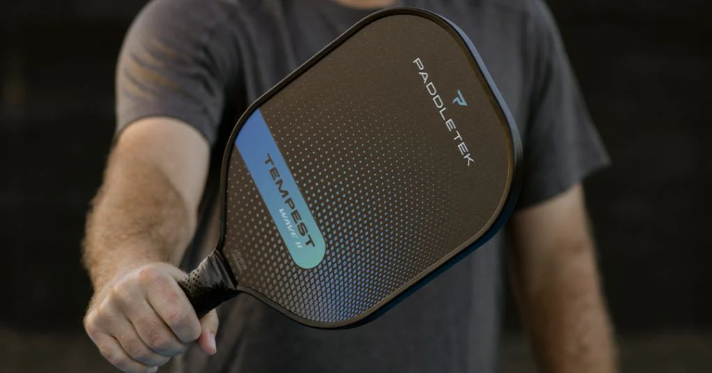 player holding a carbon fiber pickleball paddle from Paddletek