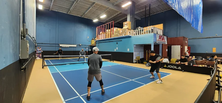 man play pickleball on badminton court